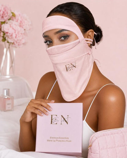 Woman wearing a pink face mask and headband, holding a pink box with 'EN' branding, against a pink background.